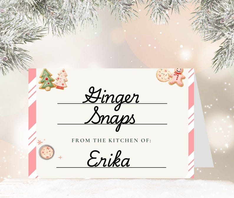 May include: A festive card with the words "Ginger Snaps" in elegant script, with the text "From the kitchen of: Erika" below. The card features pink and white striped accents and gingerbread cookie illustrations, perfect for the holiday season.