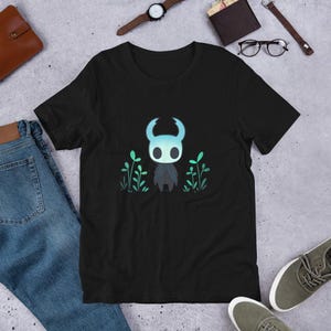 Glowing Hollow Knight T-Shirt – Chibi Knight in Forest Indie Game Tee, Lush Green Gamer Shirt, Video Game Aesthetic Unisex Apparel