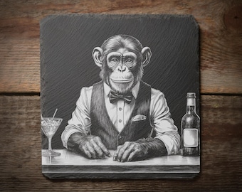 May include: Black and white illustration of a chimpanzee in a waistcoat and bow tie, behind a bar. A cocktail and a bottle are on the bar. The image is on a square, dark gray slate coaster, with a wooden background.