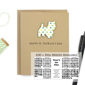 May include: A brown card with a white silhouette of a dog with a green shamrock pattern. The card says "Happy St. Patrick's Day" and "200+ Dog Breeds Available". The card also has a chart with different dog breeds and the text "That's My Dog".