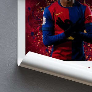 May include: A soccer player wearing a red and blue jersey with a white Nike logo and the number 10 on the chest. The player is standing with their arms crossed and a determined expression on their face. The background is a red and gold abstract design.
