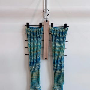 May include: A rustic wooden sign with the text "Welcome to our home" in white lettering. The sign features a distressed finish and a simple, inviting design, perfect for a front porch or entryway.