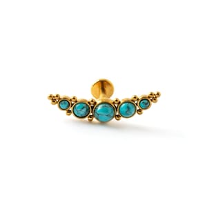 May include: A gold-colored, curved earring with five turquoise-colored stones. The earring has a flat back and a post for piercing. The stones are oval-shaped and set in a gold-colored metal. The earring is designed to be worn on the ear.