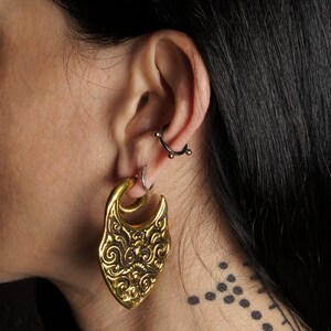 model wearing Cora golden ear weights hangers for stretched ears 4mm (6g) gauge earring