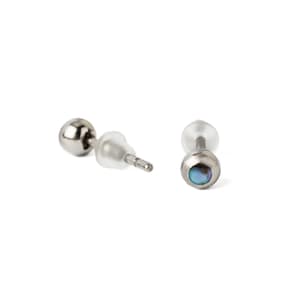 May include: A pair of silver stud earrings with a small iridescent blue gemstone in the center of each earring.