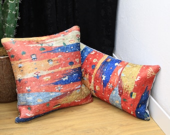May include: Two decorative throw pillows with a red, yellow, and blue patterned design. The pillows feature a whimsical, abstract design with small figures and geometric shapes.