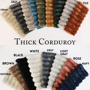 May include: A display of thick corduroy fabric swatches in various colors, including cream, dark gray, beige, teal, khaki mustard, dark green, light pink, tile, black, white, gray, light gray, rose, navy, brown, and natural. The text "Thick Corduroy" is also visible.
