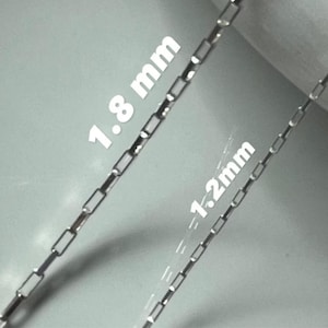 May include: Two silver chains, one 1.8 mm and the other 1.2 mm in width.