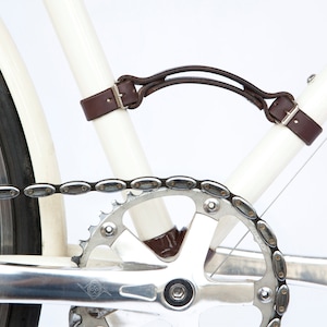 Close-up of dark brown leather "Little Lifter" bike handle on down tube and seat tube