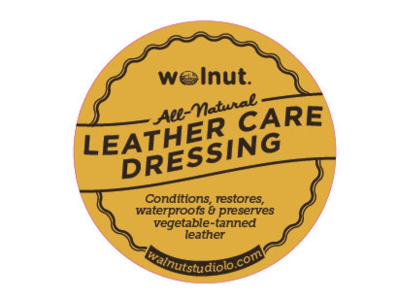 May include: A yellow round label with the text "woInut. All-Natural LEATHER CARE DRESSING" and the website "walnutstudiolo.com".