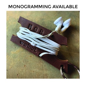 Dark brown leather headphone holder with text above that says "Monogramming Available"