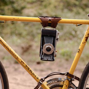 Dark brown 6-pack frame bike cinch used to creatively hold a camera.