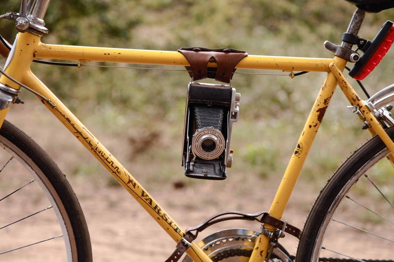 Dark brown 6-pack frame bike cinch used to creatively hold a camera.