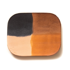 May include: A rectangular leather tray with four sections, each painted a different color: black, brown, light brown, and orange.