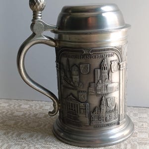 Rare Find Vintage Beer Stein Mug with Lid.The mug depicts the Greatest Cathedrals of Germany.Also coats of arms and names of cities.1950s