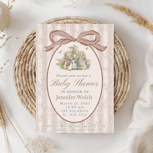 May include: Baby shower invitation with a pink and white striped background and a watercolor illustration of rabbits. The invitation includes the text "Please join us for a Baby Shower" and event details.