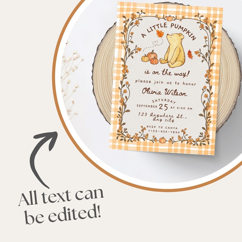 May include: A rectangular baby shower invitation card featuring a light orange and white plaid border, a central illustration of a yellow bear, pumpkins, and autumn leaves, with the text A LITTLE PUMPKIN is on the way! please join us to honor Olivia Wilson.