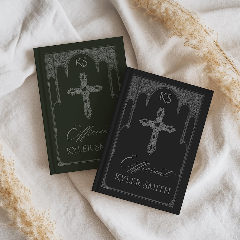 May include: Two hardback books with ornate silver cross designs. One book is dark green, the other black. Both books have the initials "KS" at the top and the word "Officiant" and the name "KYLER SMITH" in silver script.
