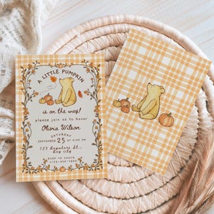 May include: Two rectangular cards featuring a yellow and white plaid pattern. One card displays a Winnie the Pooh illustration, pumpkins, and text reading A LITTLE PUMPKIN is on the way! honoring Olivia Wilson on Saturday September 25 at 6:00 PM.