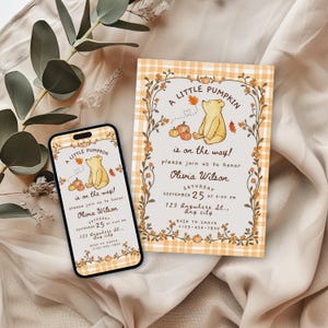 May include: A rectangular invitation card and a smartphone displaying the same design, featuring a yellow bear, pumpkins, and autumn leaves on a light background with a yellow and white plaid border. The text reads A LITTLE PUMPKIN is on the way!