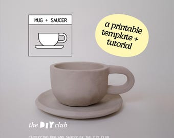May include: A cappuccino mug and saucer set in a light beige color. The mug has a rounded shape with a large handle, and the saucer is circular. Text on the image says "a printable template + tutorial" and "the DIY club".
