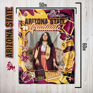 May include: A 50 x 60 inch Arizona State Graduate blanket. The blanket features a photo of a graduate, with Arizona State University graphics and text. The blanket is in maroon, gold, and black colors.