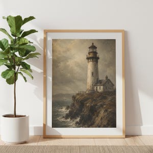 May include: A framed wall art print depicting a tall, weathered lighthouse standing on a rugged cliffside overlooking a turbulent ocean. The scene features muted, earthy tones, a cloudy sky, and a small attached building, all captured in a painterly style.