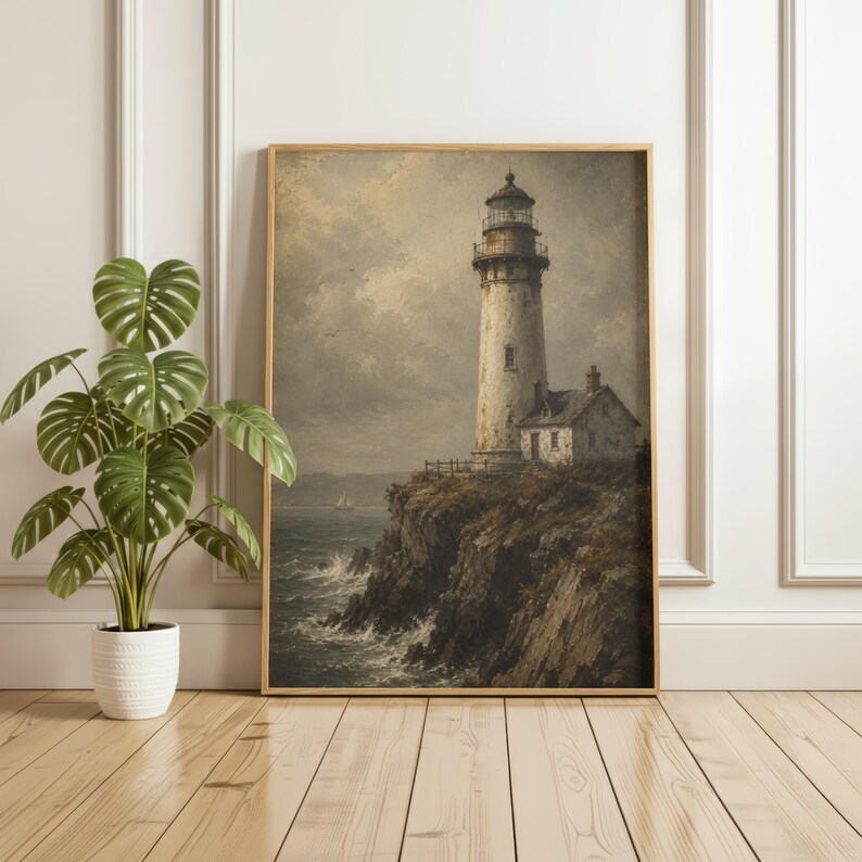 May include: A framed wall art print depicting a tall, weathered lighthouse standing on a dark, craggy cliffside overlooking a turbulent ocean with crashing waves under a cloudy, muted sky, presented in a simple, light-toned wooden frame.