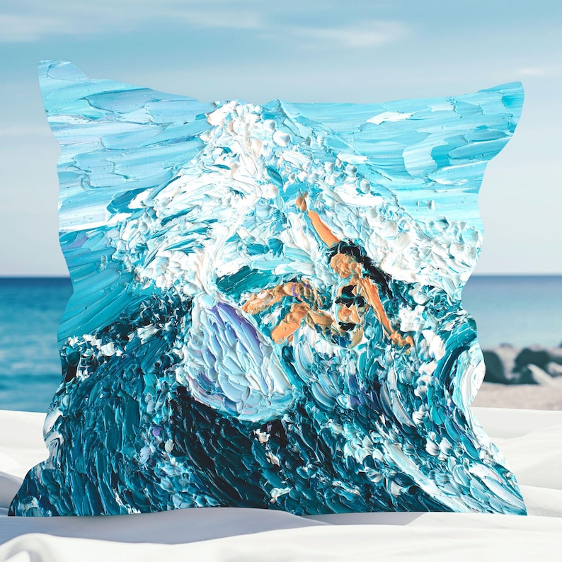 May include: A blue and white throw pillow with a painting of a person surfing a wave. The painting is done in a thick, textured style.
