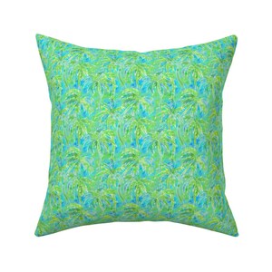 May include: A square throw pillow with a green and blue tropical palm tree pattern.