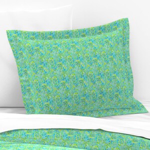 May include: A green and blue patterned pillowcase with a white background. The pattern features a repeating design of stylized palm trees.
