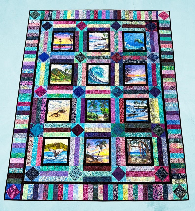 May include: A rectangular quilt featuring twelve square panels with tropical beach and ocean scenes, including palm trees, sea turtles, a whale tail, and waves. The panels are framed by a colorful border of multi-colored fabric strips.