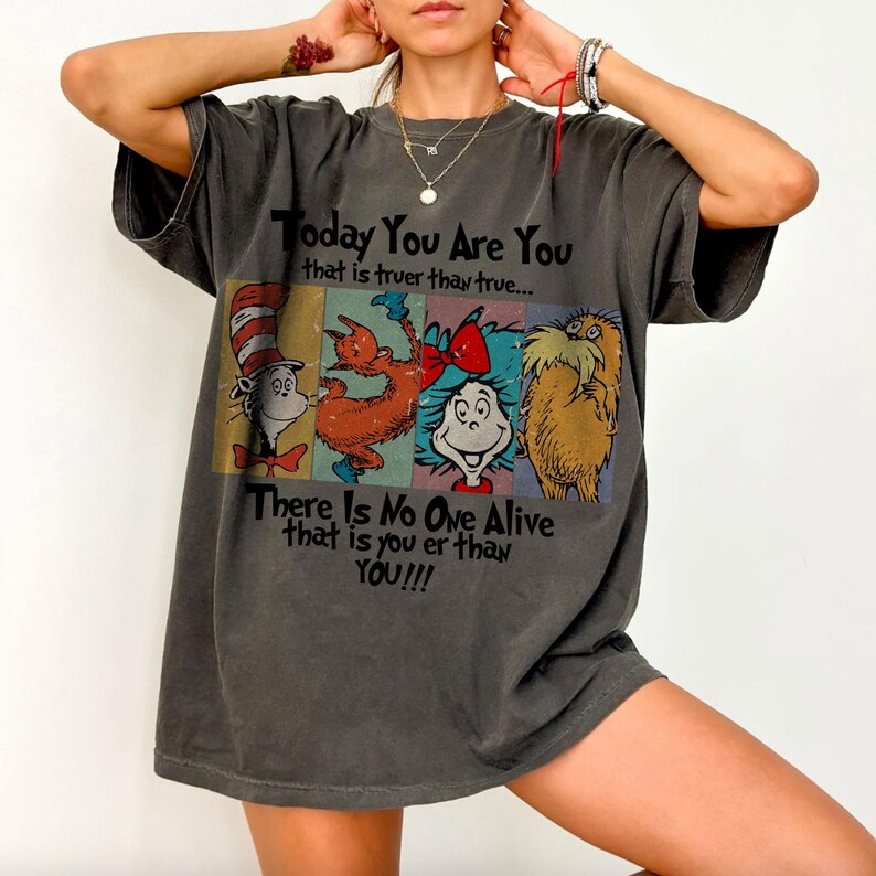 May include: Dark gray t-shirt featuring characters from a children's book. The shirt has the text "Today You Are You that is truer than true... There Is No One Alive that is you er than YOU!!!"