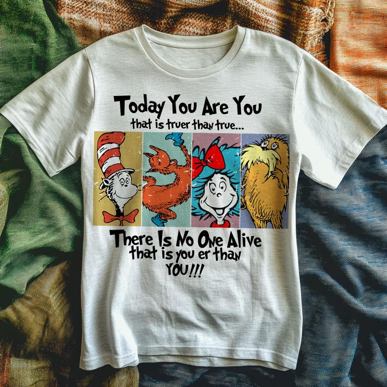 May include: White t-shirt featuring four colorful Dr. Seuss characters. The shirt has the text "Today You Are You that is truer than true... There Is No One Alive that is you er than YOU!!!" printed in black.