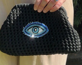black evil eye crochet clutch