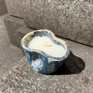 Blue stone marbled candle + reusable dish once burned.
