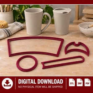 May include: Four dark red plastic cookie cutters in various shapes including a wide curved trapezoid, a crescent moon, a circle, and a long thin rectangle, displayed on a wooden surface with ceramic mugs and a bowl.