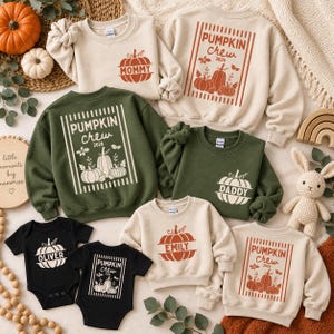 May include: A collection of matching family apparel including beige, olive green, and black sweatshirts and baby bodysuits. Each garment features pumpkin graphics and text such as Pumpkin Crew 2026, Mommy, Daddy, and Oliver, printed in white or orange.