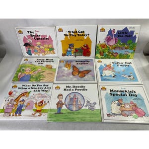 May include: A collection of eight children's storybooks featuring colorful illustrations and titles including The Bears Upstairs, What Can We Play Today?, Little Too-Tall, Away Went the Farmer's Hat, Butterfly Express, Polka-Dot Puppy, and others.