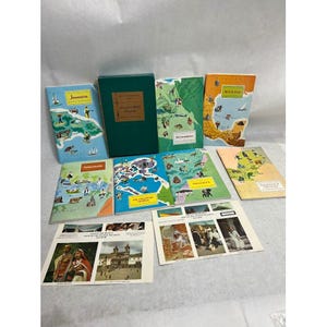 May include: A collection of Around the World Program booklets featuring illustrated maps of countries including Jamaica, Ecuador, Mexico, the Philippines, Nigeria, and Paraguay/Uruguay, alongside a dark green storage box and two photo sheets.