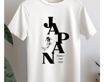 May include: White t-shirt with a black graphic design of the word "JAPAN" with a stylized koi fish swimming between the letters. The text "FAMILY TRIP 2025" is below the graphic.