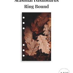 May include: A rectangular ring-bound dashboard featuring a photographic print of brown autumn oak leaves with water droplets. The text 'Seasonal Dashboards Ring Bound' appears at the top, and 'Angel Kay Studio' is printed vertically on the right side.
