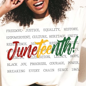 May include: A white t-shirt featuring a graphic design that reads "Juneteenth!" in red, yellow and green. The graphic is surrounded by words that describe the significance of Juneteenth, including "freedom", "justice", "equality", "history", "empowerment", "culture", "heritage", "unity", "resilience", "dignity", "respect", "pride", "community", "truth", "liberty", "strength", "celebration", "legacy", "hope", "black joy", "progress", "courage", "power", and "breaking every chain since 1865."