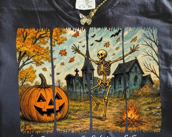 May include: Dark navy blue t-shirt with a Halloween graphic. The design shows a jack-o'-lantern, a skeleton, a church, and the text "it's the most wonderful time of the year". The shirt has a crew neck and short sleeves.