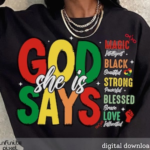 May include: Black sweatshirt with a colorful graphic that says "God she is says" with a list of positive words in a smaller font below. The words include "magic", "intelligent", "black", "beautiful", "strong", "powerful", "blessed", "brave", "love", and "influential".