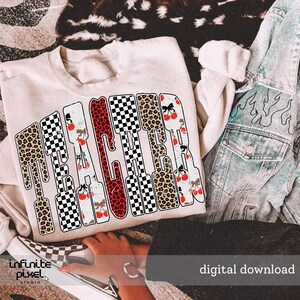 May include: A cream-colored sweatshirt with the word "TEACHER" in a bold, decorative font. The letters are filled with patterns like leopard print, checkered, and cherry designs. A denim jacket and checkered shoes are also visible.