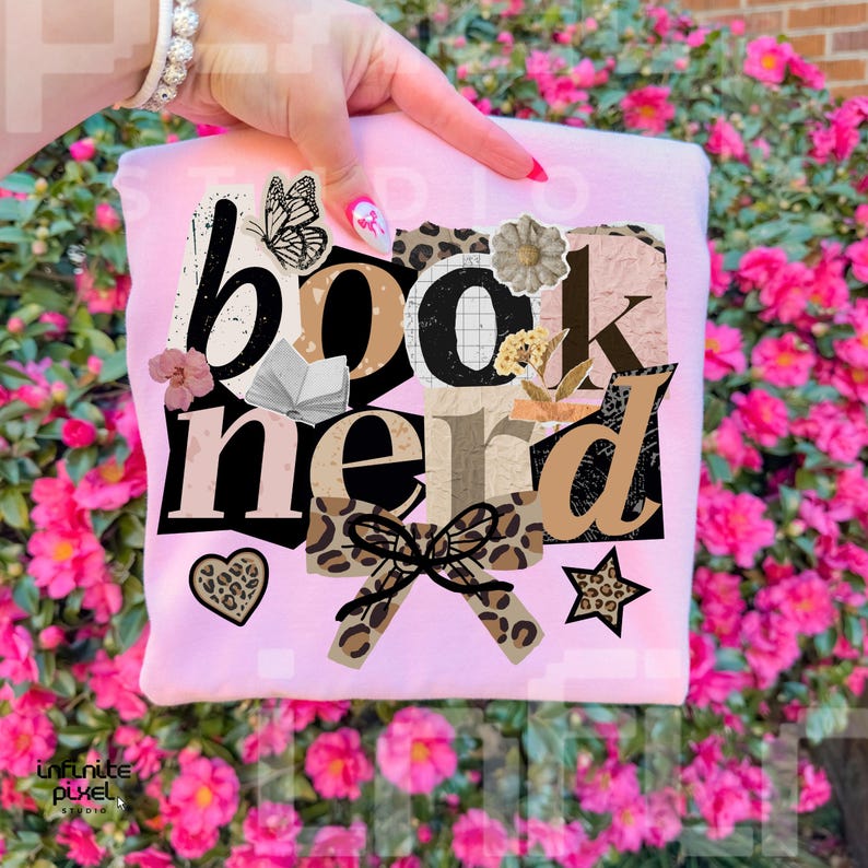 May include: A light pink sweatshirt with the words "book nerd" in a collage style design. The design includes a butterfly, a heart, a star, and a bow with a leopard print pattern. The sweatshirt is held by a person.