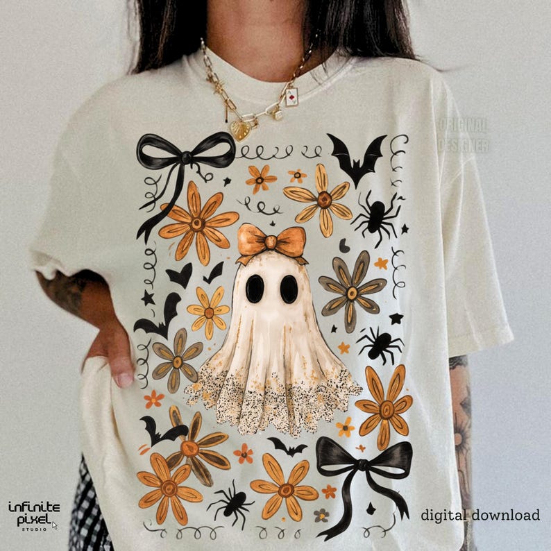 May include: Cream t-shirt with a Halloween-themed design. The illustration shows a ghost with a bow, orange flowers, black bows, spiders, and bats. The words "digital download" are visible.