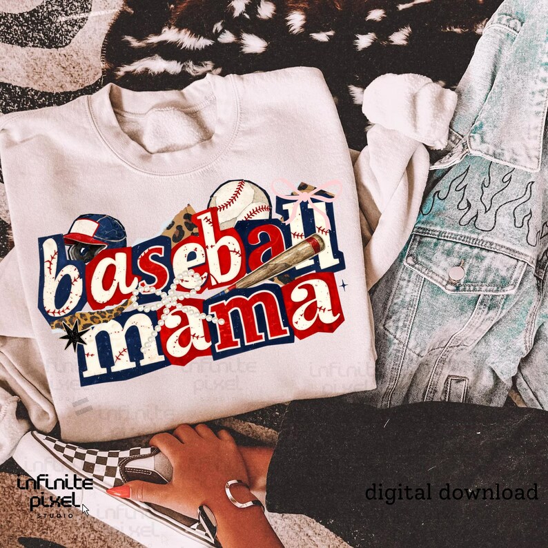 May include: Cream-colored sweatshirt with a baseball-themed graphic. The design features the words "Baseball Mama" in red, white, and blue, along with baseballs, a bat, and a baseball cap. The words "digital download" are also visible.