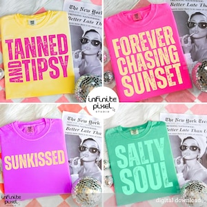 May include: Four brightly coloured t-shirts with large text: yellow "TANNED AND TIPSY", pink "FOREVER CHASING SUNSET", purple "SUNKISSED", and green "SALTY SOUL". Each has a crew neck and short sleeves. The shirts are shown with disco balls and a newspaper.